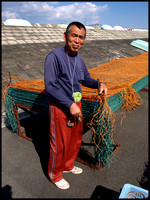 Fisherman stretching nets, Ariake Sea, Saga