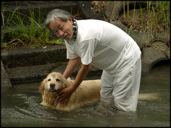 Man and dog, bathing